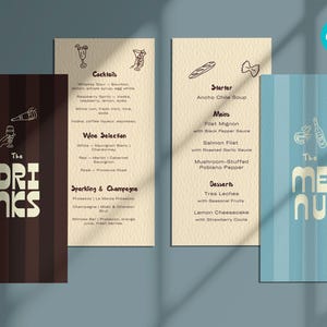 May include: Three menu cards with a dark brown, beige, and light blue background. The dark brown card says "The DRINKS" in white. The beige card lists cocktails, wine, and sparkling options. The light blue card says "The MENU".
