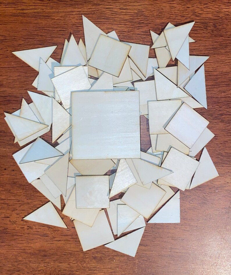 May include: A pile of white wooden squares and triangles. The shapes are arranged in a random pattern.