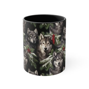 May include: A ceramic coffee mug with a black interior and a wrap-around design featuring a pattern of wolves, evergreen branches, red berries, and snow. The wolves have gray and brown fur.