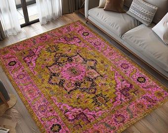 May include: A pink and gold area rug with a traditional Persian design. The rug has a central medallion with intricate details and a floral border.