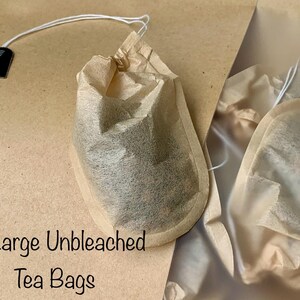 May include: Ten large unbleached tea bags in brown paper packaging. The tea bags are made of natural, unbleached paper and are designed for loose leaf tea. The packaging is labelled with the text "10 Large Unbleached Tea Bags".