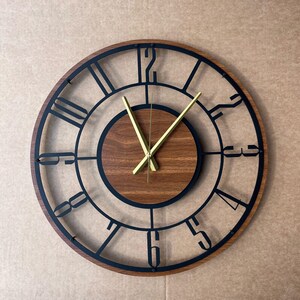 A wall clock with a wooden frame and a black metal frame, displaying the time as approximately 10:10.
