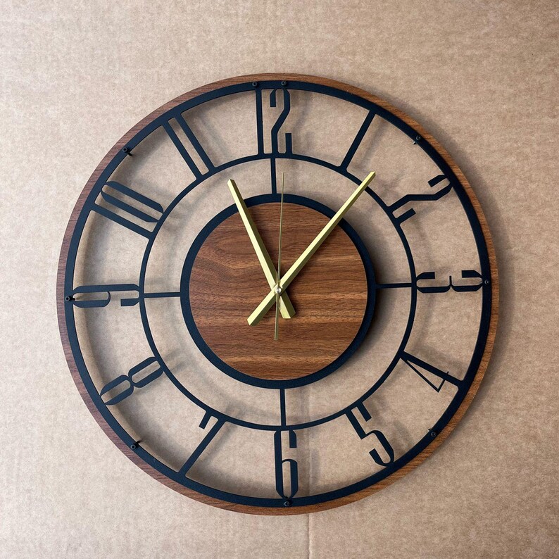 A wall clock with a wooden frame and a black metal frame, displaying the time as approximately 10:10.
