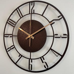 Modern metal wall clock styled in neutral-toned living room