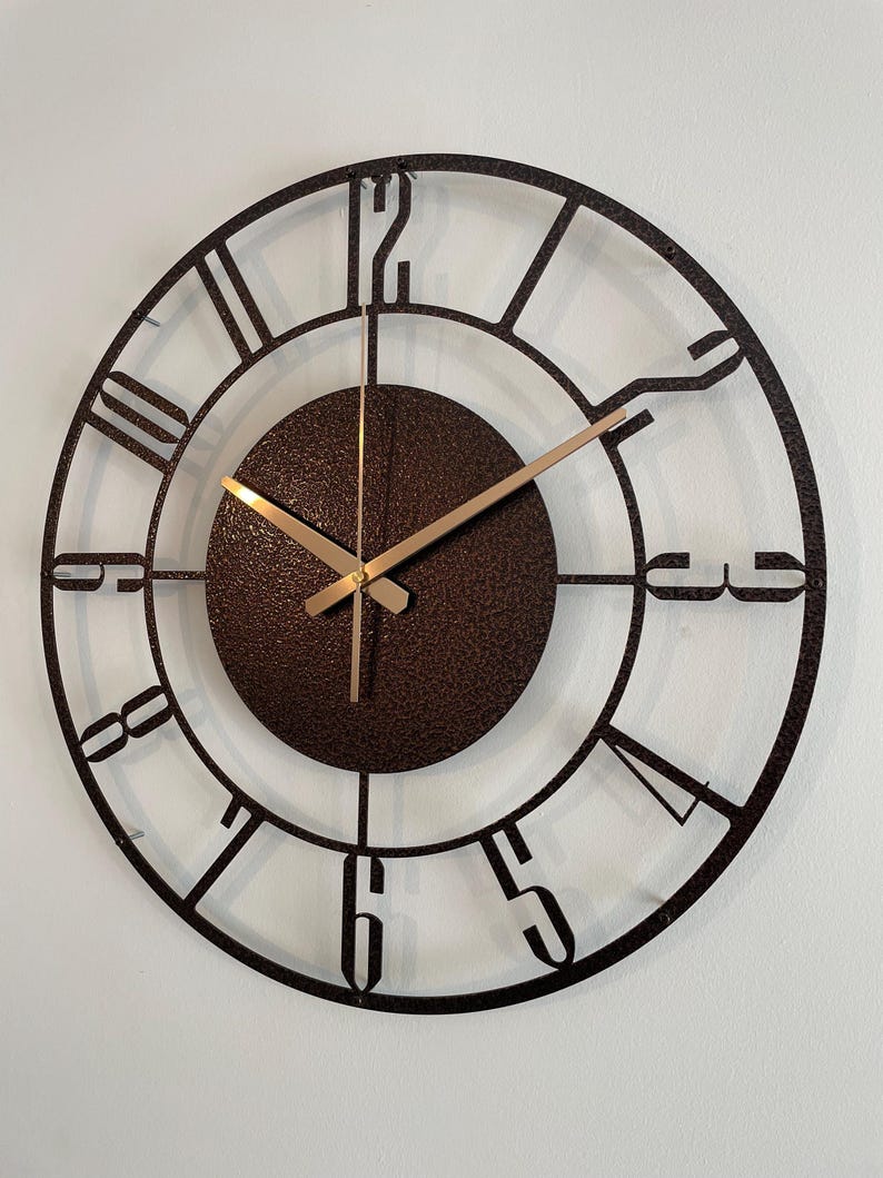 Modern metal wall clock styled in neutral-toned living room