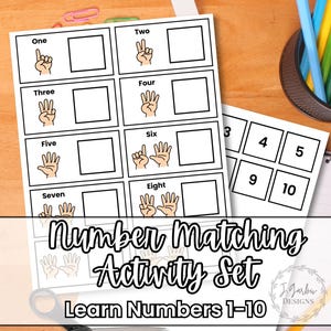 May include: A white number matching activity set with illustrations of hands showing numbers 1-8, and number cards 3-5 and 9-10. The set includes the text "Number Matching Activity Set Learn Numbers 1-10". Pencils and scissors are also visible.
