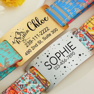May include: Two personalized dog tags with colorful patterned straps. The gold tag has a mountain scene and the text "Chloe 239-111-2222 490 2nd St, Suite 300". The silver tag has stars and the text "Sophie 123-456-7890".