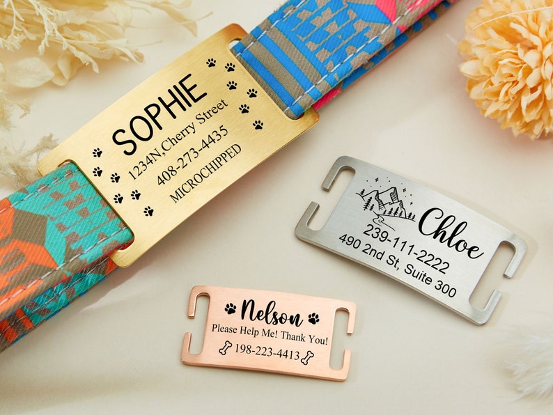 May include: Three gold, silver, and rose gold dog tags with engraved text. The tags include the names Sophie, Chloe, and Nelson, along with contact information and a microchip symbol.