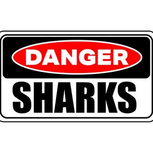 May include: A rectangular sign with a black border and white background. The top section features the word "DANGER" in white letters on a red oval, set against a black background. The bottom section reads "SHARKS" in bold black letters.