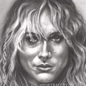 May include: A black and white graphite pencil portrait of a person with long wavy hair, a septum ring, and facial piercings. The subject wears a choker necklace with a central square pendant. The text @PORTRAIT BY SYL is visible on the lower right.