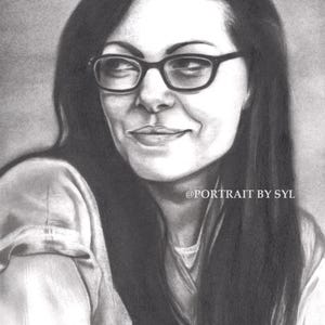 May include: A grayscale pencil portrait of a person with long dark hair and glasses. The person is smiling slightly. The text "@PORTRAIT BY SYL" is visible in the image.