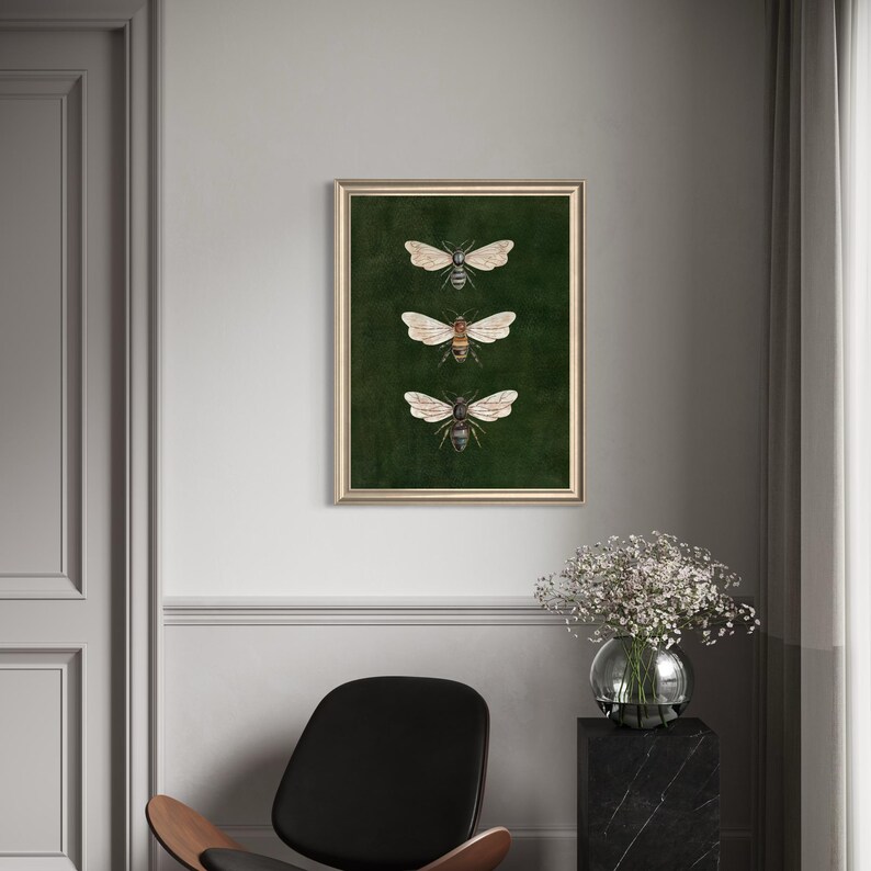 May include: A rectangular wall art print in a thin gold frame featuring three detailed illustrations of bees arranged vertically against a dark forest green background. Each bee is depicted with spread wings and distinct body markings in shades of brown.