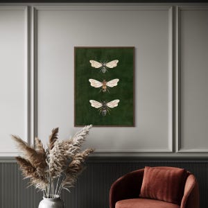 May include: A rectangular wall art print featuring three detailed illustrations of bees arranged vertically. The bees are depicted with translucent wings and brown and black bodies, set against a solid, deep forest green background within a thin brown frame.