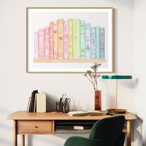 May include: A watercolour print featuring a collection of books in pastel shades. Titles visible include "Sherlock Holmes," "The Hobbit," and "Emma." The artwork is displayed in a gold-coloured frame, adding a touch of elegance to the scene.