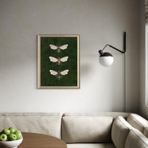 May include: A framed wall art print featuring three detailed illustrations of bees arranged vertically. The bees are depicted with translucent wings and brown and black bodies, set against a solid, deep forest green background.