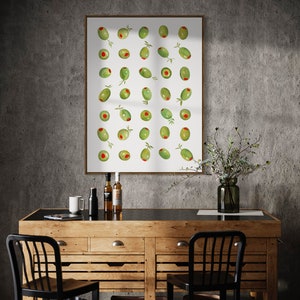 May include: A framed print featuring a watercolor illustration of green olives with red centers and small green leaves. The artwork hangs above a wooden cabinet with black chairs, bottles, and a vase.