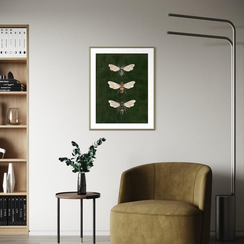May include: A framed wall art print featuring three detailed illustrations of bees arranged vertically against a solid dark green background. The artwork is enclosed in a thin gold frame, showcasing the insects with wings spread wide.
