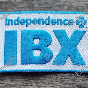 May include: White embroidered patch with blue lettering that reads "Independence IBX".