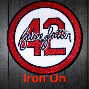 May include: Red, white, and blue iron-on patch with the number 42 and the signature "Bruce Sutter" in a white circle with a red outer ring. The text "Iron On" is printed below the patch.
