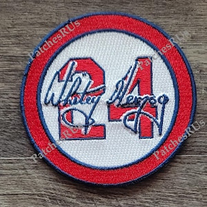 May include: Red, white, and blue embroidered patch with the number "24" and the signature "Whitley Merman".