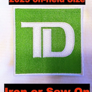 May include: Embroidered patch with a green square and white border. The patch features the white letters "TD" in a stylized font. The text "2025 on-field Size" is above the patch, and "Iron or Sew On" is below.