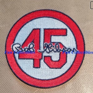 May include: Red and white embroidered patch with the number 45 in red and a signature in black. The patch has a red border and a white background.