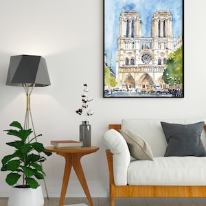 Op de afbeelding: Een aquarel schilderij van de Notre Dame kathedraal in Parijs, Frankrijk. Het schilderij is zwart ingelijst en hangt aan een witte muur boven een witte bank met een houten frame. Een kleine houten bijzettafel met een boek erop staat voor de bank.