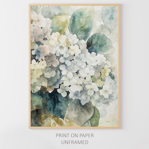 May include: Watercolor print of white and light blue hydrangea flowers with green leaves, set in a light brown wooden frame. The artwork has a soft, muted color palette and is labeled "PRINT ON PAPER UNFRAMED".
