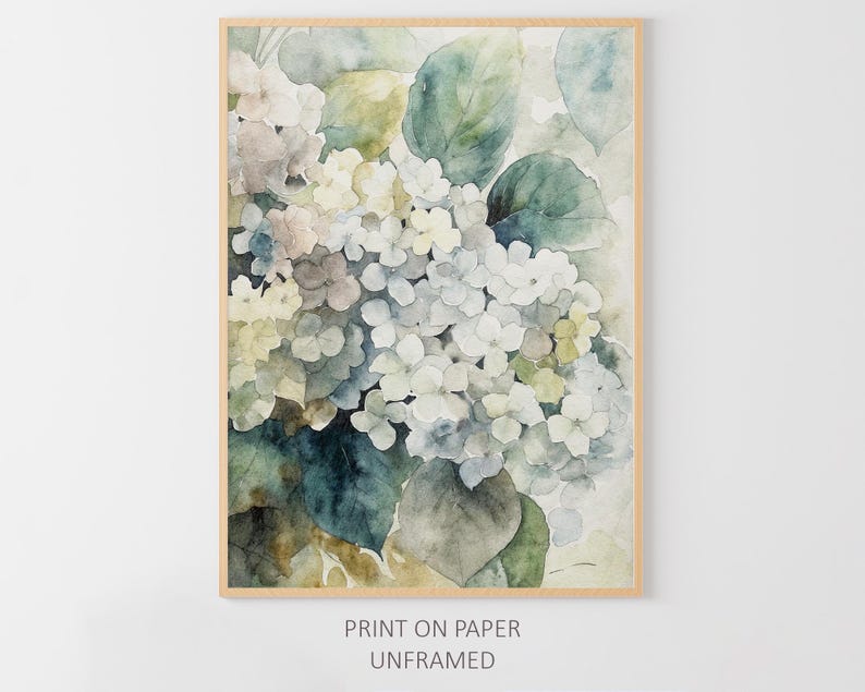 May include: Watercolor print of white and light blue hydrangea flowers with green leaves, set in a light brown wooden frame. The artwork has a soft, muted color palette and is labeled "PRINT ON PAPER UNFRAMED".