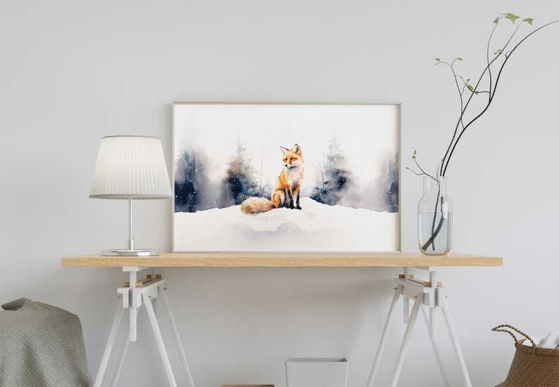 May include: A watercolor painting of a red fox sitting in a snowy forest. The fox is looking to the right, and the background is a soft blue and gray.