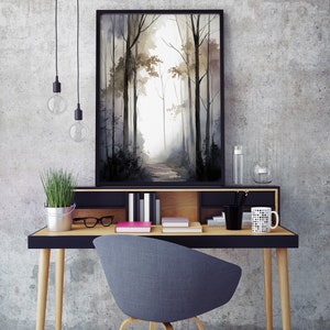 May include: A black framed watercolor painting of a forest path with trees on either side. The painting is hanging on a gray wall above a wooden desk with a black top. There is a gray chair in front of the desk.