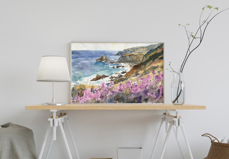 May include: Watercolor painting of a coastal landscape with a rocky coastline, blue ocean, and purple wildflowers in the foreground.