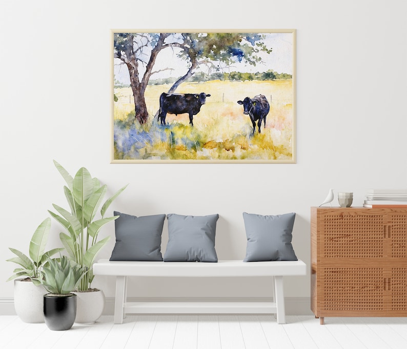 May include: Watercolour painting of two black cows standing in a field with a tree in the background. The cows are facing each other and the tree is in the top left corner of the painting.