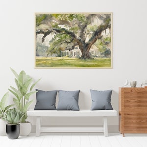 May include: A watercolor painting of a white house with a large oak tree in the front yard. The house has a porch and a roof with a slight pitch. The tree has a thick trunk and branches that spread out over the house. The painting is framed in a light brown frame.
