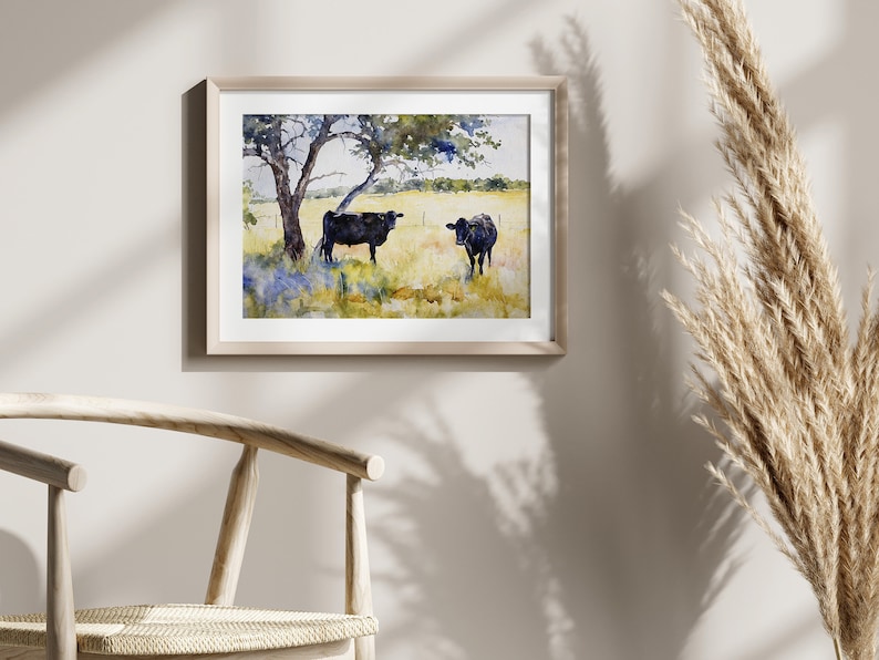May include: Watercolour painting of two black cows in a field with a tree in the background. The cows are standing in a grassy field with blue wildflowers.