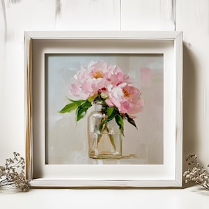 May include: A framed painting of pink peonies in a clear glass vase. The artwork features a soft, impressionistic style with visible brushstrokes. The flowers have yellow centers and green leaves, set against a neutral background.