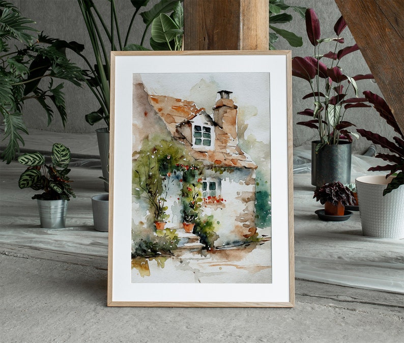 May include: A watercolor painting of a small cottage with a red tile roof and a white stone facade. The cottage has a window with a view of a lush green garden. The painting is framed in a light wood frame.