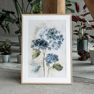 May include: A watercolor painting of blue hydrangeas on a white background with a wooden frame.