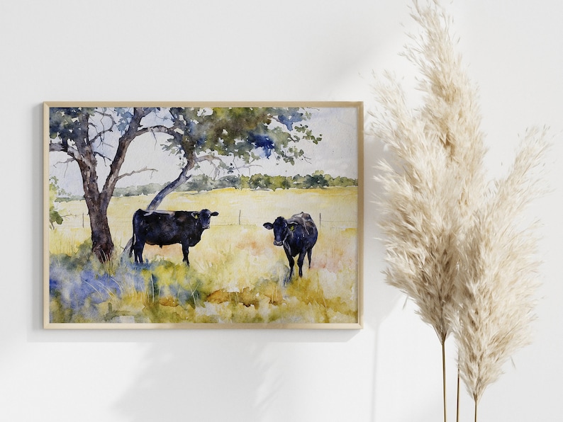 May include: Watercolour painting of two black cows standing in a field with a tree in the background. The cows are facing different directions and the field is a mix of green and yellow.