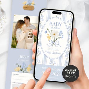 May include: A baby shower invitation and a smartphone showing a digital invitation. The digital invite has floral designs and the text "Baby in Bloom." The printed invite includes a photo and RSVP details, all in shades of blue.