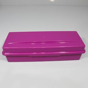 May include: A rectangular, bright pink plastic storage box with a hinged lid.