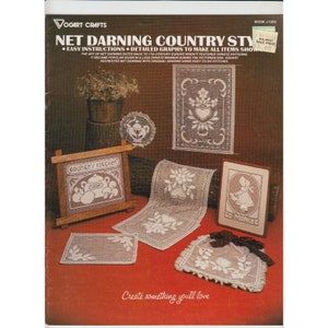 May include: A vintage craft book cover featuring the title "Net Darning Country Style" and a photograph of various net darning projects, including a country kitchen scene, a heart-shaped design, and a "To Market" scene.