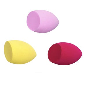 May include: Three colorful makeup sponges in a teardrop shape. One is light purple, one is yellow, and the third is a deep pink. The sponges are arranged against a white background, showcasing their smooth, porous texture.