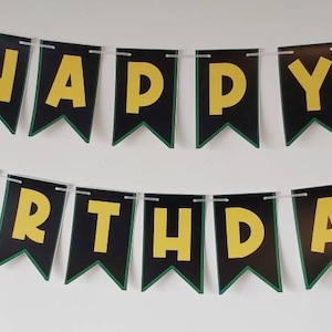 May include: A black and green banner with the words "Happy Birthday" in yellow letters. The banner has a Jamaican flag on each end.