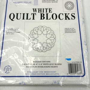 May include: A package of white quilt blocks with the text "White Quilt Blocks" and "Pattern #33 Interlocking Hearts." The package contains six 18 x 18 inch blocks. The package also includes the text "Needleart for Embroidery."