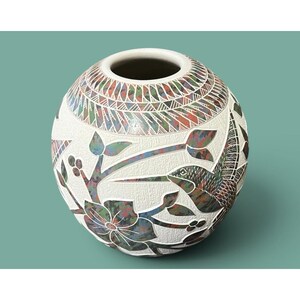 May include: A spherical ceramic vase with a textured white surface featuring inlaid multicolored patterns. The design includes a hummingbird, floral motifs, and geometric borders in shades of red, green, and blue, with a circular opening at the top.