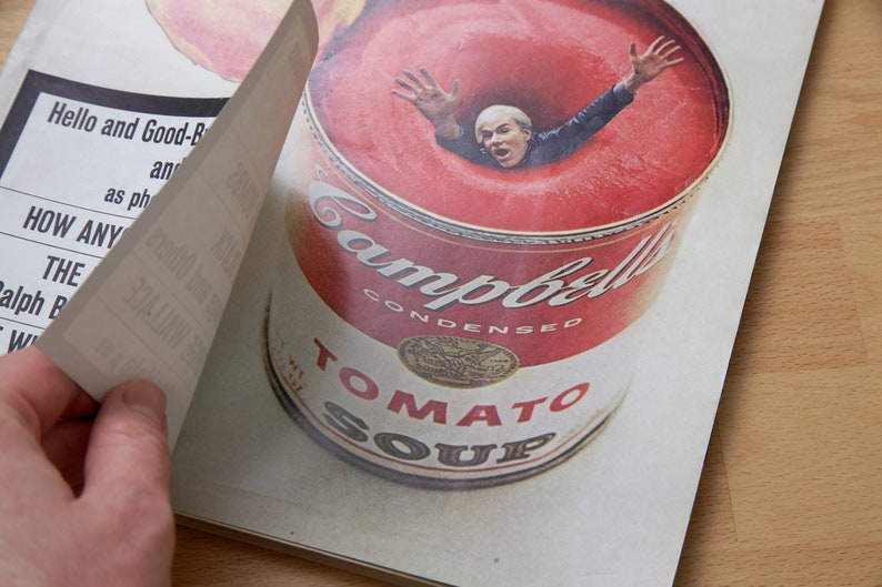 May include: A red and white Campbell's Condensed Tomato Soup can with a person's head submerged in the soup. The person is wearing a blue shirt and has their arms outstretched.