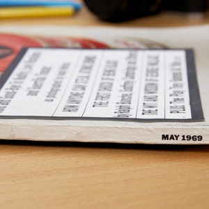 May include: Close-up of the spine of a magazine with the text "MAY 1969" printed on the bottom edge. The magazine cover is white with a black and white image of a woman's face.