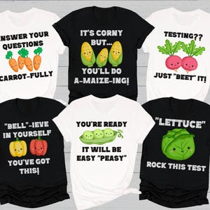 May include: Six different t-shirts with vegetable puns. The shirts are white and black with colorful cartoon vegetables. The shirts have text that says "Answer your questions carrot-fully", "It's corny but... you'll do a-maize-ing!", "Testing?? Just "beet" it!", "Bell-ieve in yourself you've got this!", "You're ready it will be easy "peasy"", and "Lettuce rock this test".