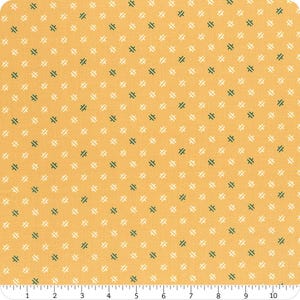 May include: A yellow fabric with a repeating pattern of white and green crosses.